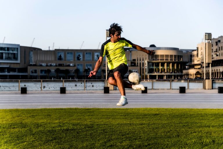 man in green shirt playing soccer
