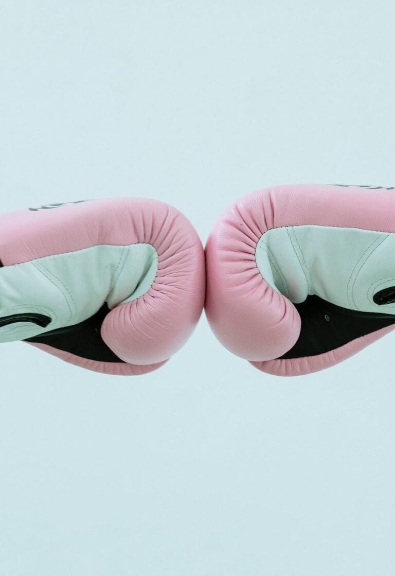 unrecognizable boxers in boxing gloves giving fist bump in studio