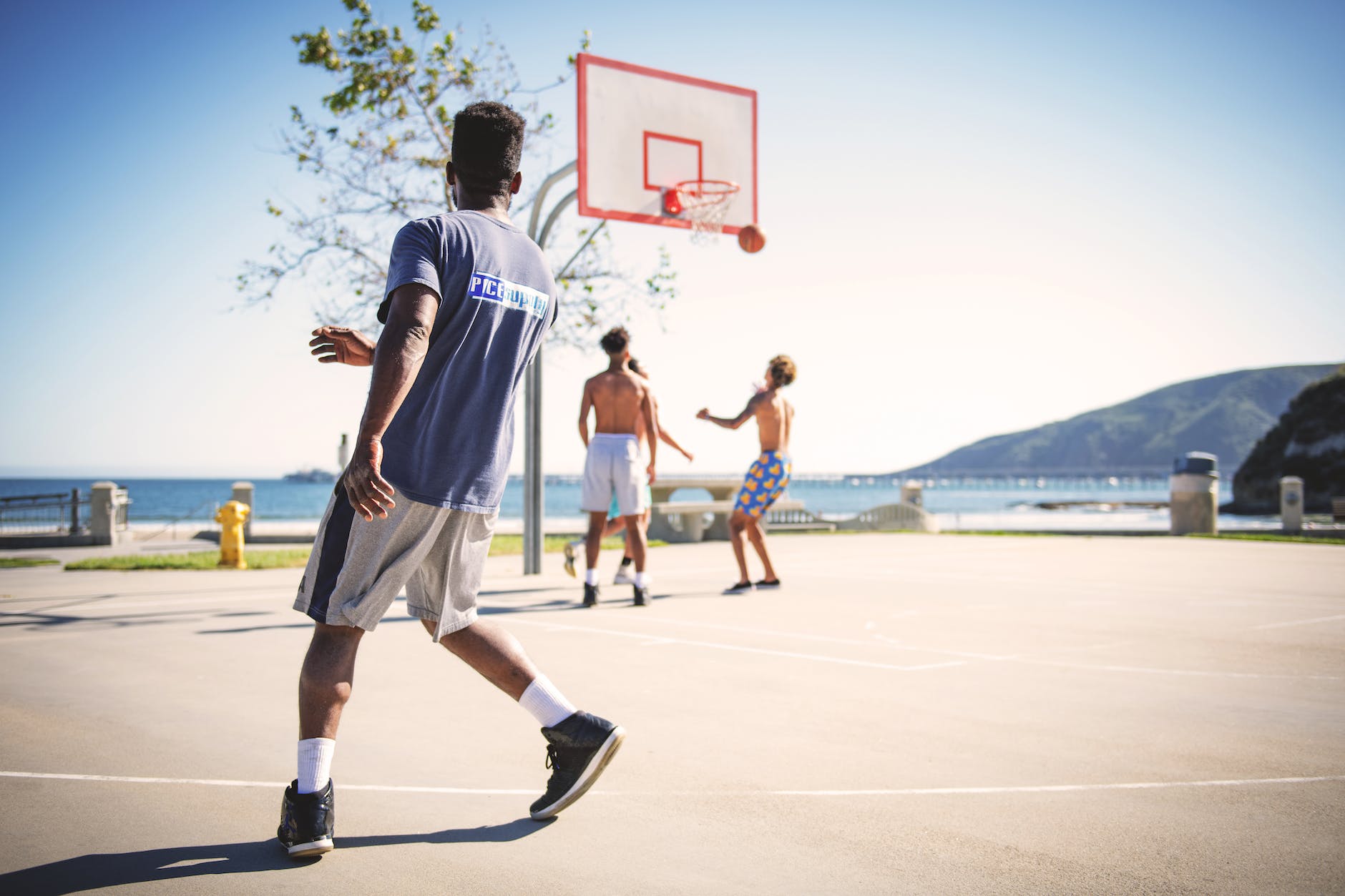 four people playing basketball